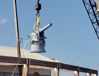 German WWI 88 millimeter cannon is hoisted into place at the Graveyard of the Atlantic Museum.