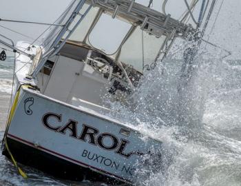 The Caro-lina being battered by the surf after beaching.