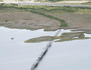 the remnants of the first bridge to span New Inlet can be clearly seen in this aerial view.
