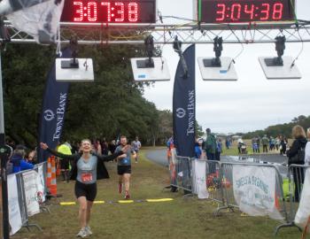 The joy of crossing the half marathon finish line at the Outer Banks Half Marathon.