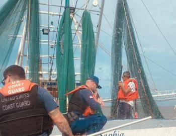 Coast Guard watercraft approaches shrimp boat Miss Sohpia for rescue.