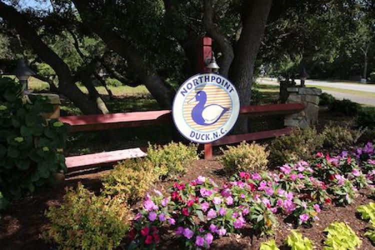 northpoint duck nc sign with flowers around the sign