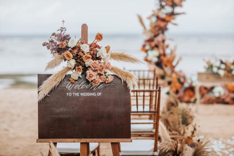 wedding on the beach with fall colored flowers