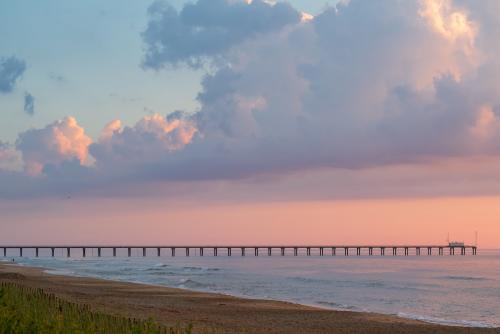 sunset in Duck, North Carolina with view of pier and ocean
