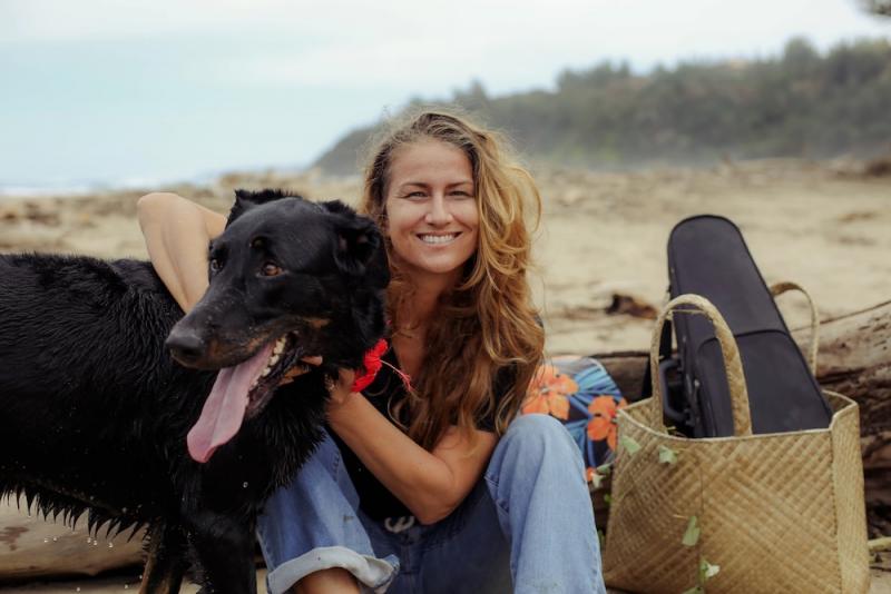 woman on the beach with her dog
