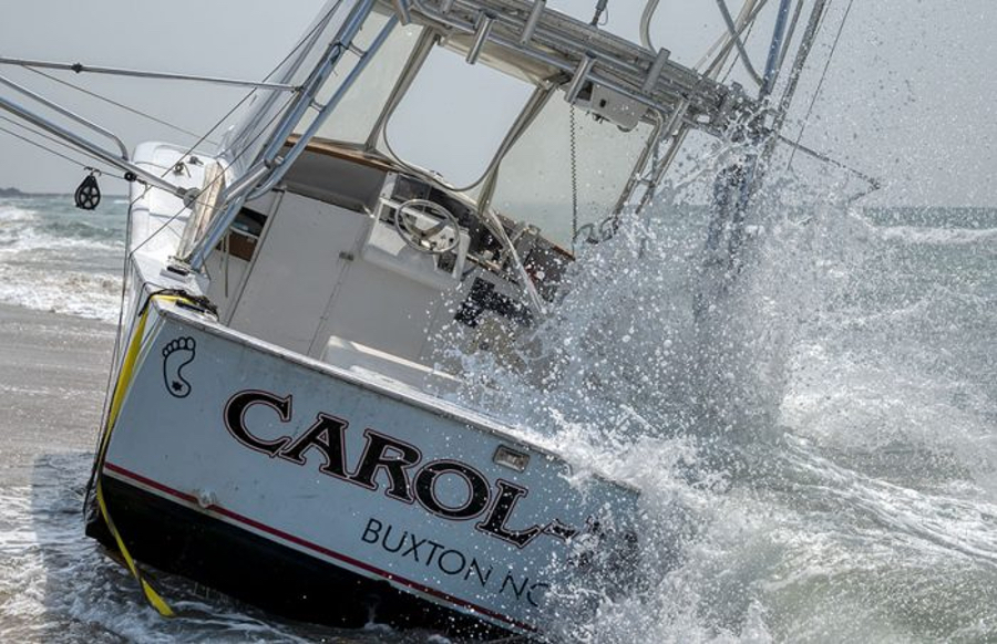 The Caro-lina being battered by the surf after beaching. Photo: Donny Bowers, Island Free Press