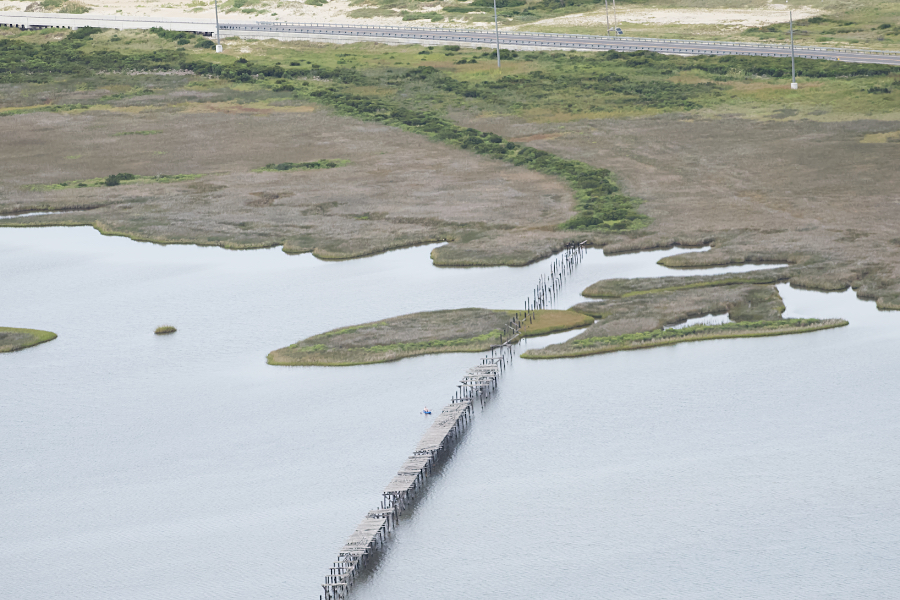 the remnants of the first bridge to span New Inlet can be clearly seen in this aerial view.