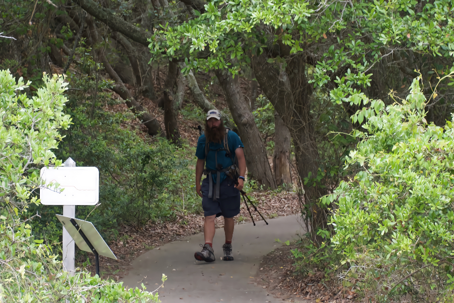 Ending his 1175 mile trek, Trail Marshall emerges from Jockey's Ridge foliage.