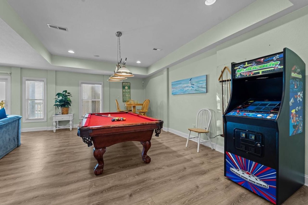 game room at an outer banks rental showing a pool table and arcade game
