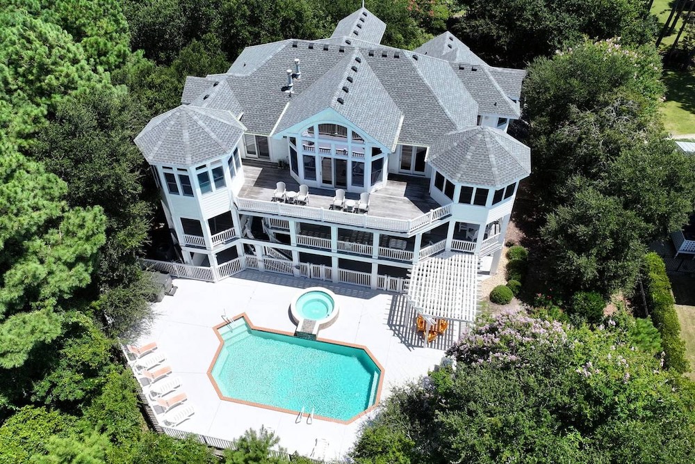 aerial view of outer banks vacation home with view of pool and hot tub