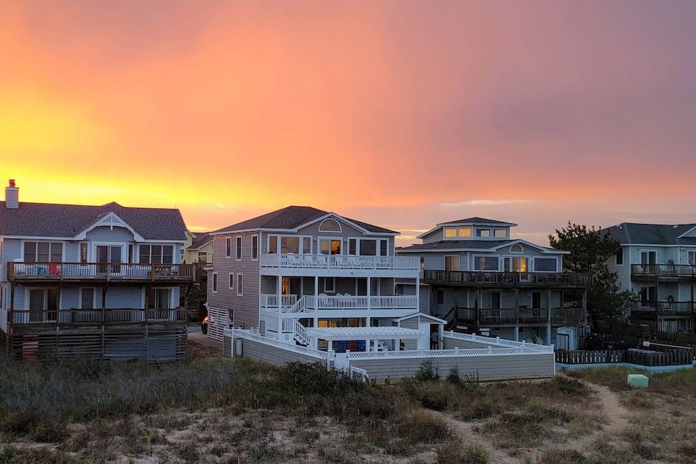 outer banks vacation home at sunset with view of beach