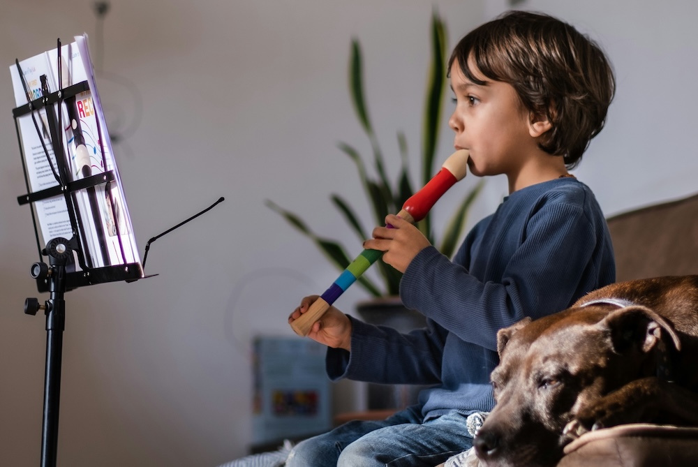 little boy playing a recorder