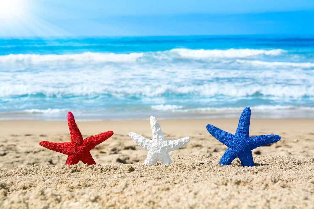 red white and blue starfish on beach for fourth of july